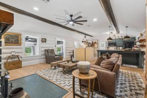 a living room with a couch and a table at 3BR Cabin Sleeps 10 Fenced Yard in Oklahoma City