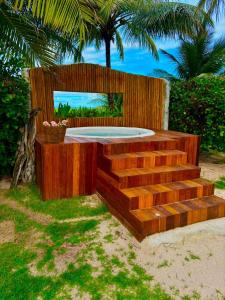 a wooden stage with stairs and a palm tree at Villa Cote Sud Pousada De Charme - Pé na Areia in São Miguel dos Milagres +112 photos