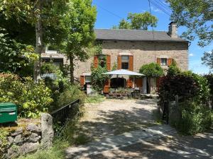 an old stone house with a garden in front of it at Chez Rose-Laure in Grandviala