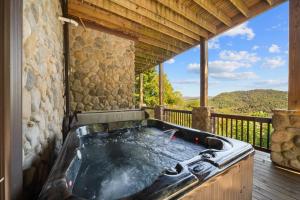 a hot tub on a deck with a view at Cranberry View Lodge in Newland