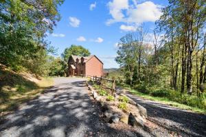 a dirt road leading to a red barn at Cranberry View Lodge in Newland