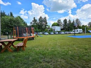 a park with a picnic table and a playground at Oaza Pieczyska in Koronowo
