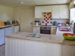 a kitchen with white cabinets and a counter top at Lily Pad 1 - Uk49648 in Nassington