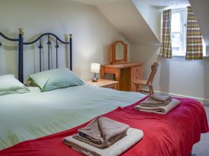 a bedroom with a bed with towels on it at Lily Pad 1 - Uk49648 in Nassington +16 photos