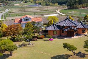an aerial view of a house with a yard at Boseong Carmel Royal Pension in Boseong