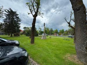 a car parked in a park with a cemetery at Penzion Nord in Hora Svatého Šebestiána