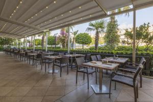 a row of tables and chairs in a restaurant at Crystal Waterworld Aqua Collection - Ultimate All Inclusive in Belek