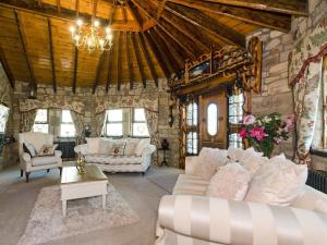 a living room with couches and a stone wall at Tennox Parlour - Ukc3542 in Kilbirnie