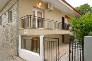 an apartment building with a balcony and a fence at Elia Apartments in Ierissos