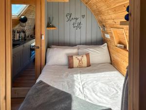 a bed in a tiny house with a sign on the wall at The Rounton - Ukc9284 in Brompton