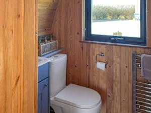 a small bathroom with a toilet and a window at The Rounton - Ukc9284 in Brompton +2 photos
