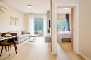 a living room with a couch and a bed and a table at Boka Bay by MN Property in Dobrota +31 photos