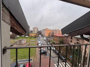 a view of a city street from a balcony at L'Archè - The Rustic Loft in Cinisello Balsamo