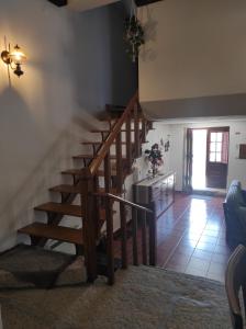 a staircase in a living room with a stair case at Casa do Lagar in Almeida