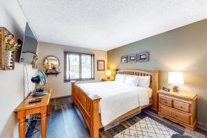 a bedroom with a large bed and a desk with a lamp at Sunrise 8 in Mammoth Lakes +78 photos