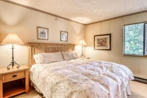 a bedroom with a bed and two lamps and a window at The Summit 5 in Mammoth Lakes +100 photos