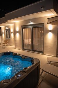 a jacuzzi tub in a room with a table at CASA Terraya in Afantou