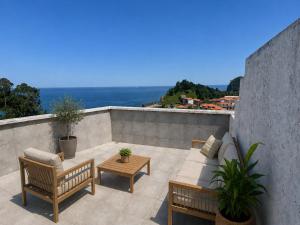 a patio with a couch and chairs and a table at Hotel Arresi in Arminza