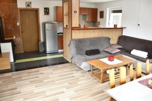 a living room with a couch and a table at Počitniška hiša REMA in Lendava
