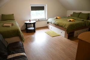 a small room with two beds and a window at Počitniška hiša REMA in Lendava