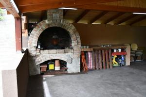 a large brick oven in a house with a table at Počitniška hiša REMA in Lendava
