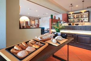 a table with a tray of bread and pastries at Hotel Elvezia Ascona in Ascona