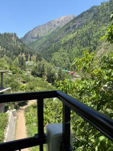 a view of the mountains from a balcony at The Soul Himalaya in Tosh +16 photos