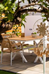 a wooden picnic table with chairs around it at CASA Terraya in Afantou