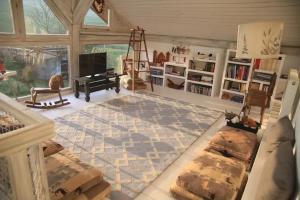 a living room with a grand piano and a living room with a rug at Cross Country Farm in Prod +26 photos