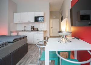 a small room with a bed and a white table at Hotel Nuhnetal in Winterberg