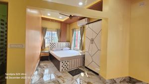 a bathroom with a tub and a sink in a room at Akshay Guest House in Krishnanagar