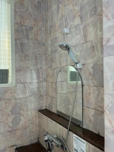 a shower with a shower head in a bathroom at マリーナベイCentral in Atami +40 photos