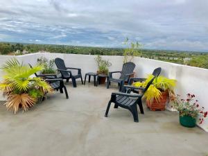 a group of chairs and tables on a balcony at Termas Del Sol in Termas de Río Hondo