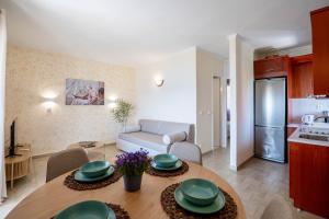 a kitchen and a living room with a table in a room at Corfu Glyfada Beach Apartment in Glyfada