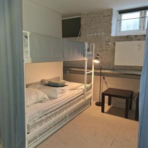 a bedroom with two bunk beds and a table at Craizy Hans in Odense