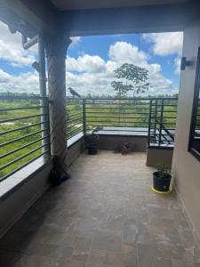 a balcony with a view of a field at Sisa Omi Apartments in Wanica