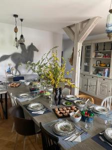 a dining room table with a horse on the wall at Cross Country Farm in Prod