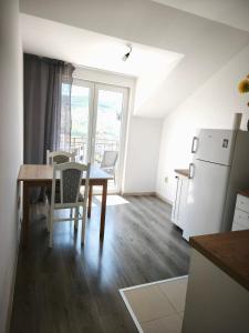 a kitchen and dining room with a table and a refrigerator at Montenegro Summer time in Igalo