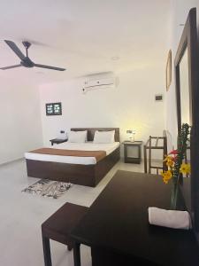 a bedroom with a bed and a ceiling fan at Arcadiaa Villa in Polonnaruwa