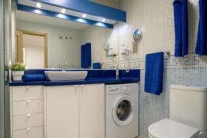 a bathroom with a sink and a washing machine at GOLDEN BEACH MOGAN in Puerto de Mogán