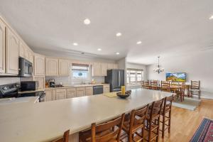 a large kitchen with a table and chairs in it at Oma's Beech House in Beech Mountain