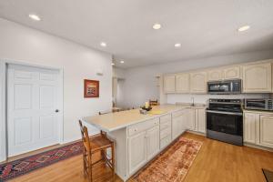 a kitchen with white cabinets and a counter top at Oma's Beech House in Beech Mountain +33 photos