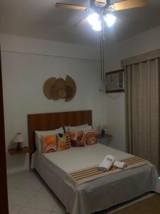 a bedroom with a bed with a ceiling fan at Upwind in Araruama