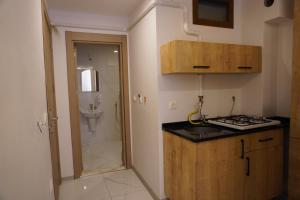 a small kitchen with a sink and a shower at Dünya Apart in Çaykara +50 photos