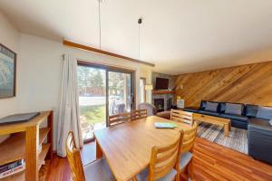 a living room with a table and a couch at Snowcreek 27 in Mammoth Lakes