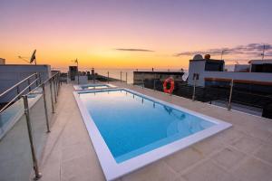 a swimming pool on a cruise ship at sunset at Arguineguin Sun Beach in Arguineguín