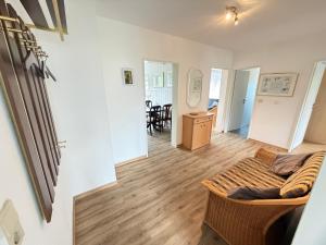 a living room with a couch and a table at Steilsand 1 - 200 M Zum Strand in Cuxhaven