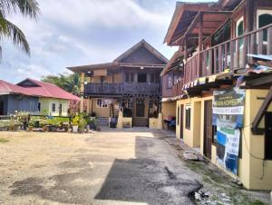 a building with a sign in front of it at Warisan Homestay A in Mersing