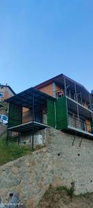 a large building with a green wall on it at LEYLİ GABAN VİLLA in Çaykara