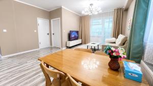 a living room with a dining room table and a couch at Stylish Cozy Apartment in UB in Ulaanbaatar